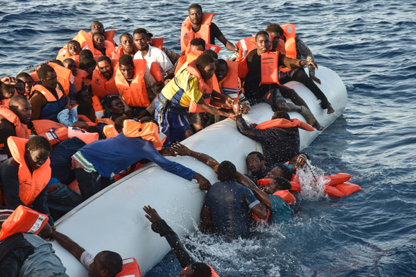 Migrants and refugees panic as they fall in the water during a rescue operation of the Topaz Responder rescue ship run by Maltese NGO Moas and Italian Red Cross, off the Libyan coast in the Mediterranean Sea, on Thursday (AFP photo)